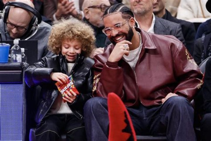 
Drake’s Son Adonis Snacks on Skittles While Watching Raptors Game with Dad from Courtside Perch 